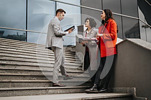Business associates discussing strategy on office stairs outdoors