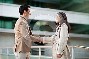 Business Associates Man And Woman Greet Each Other Warmly