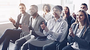 Business audience applauding to speaker at conference