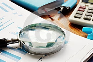 Business audit. Magnifying glass on financial documents
