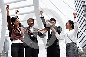 Business background of asian business people being cheerful for being winner in business competition contest with hand holding