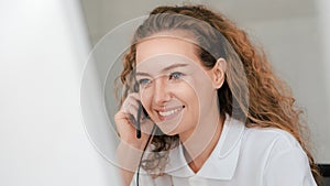 Business background of caucasian female customer service agent on telephone service to customers at helpdesk call center