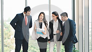 Business background of group of businesspeople standing together and having business discussion in office