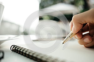 Business background hand of businessman with pen write on blank