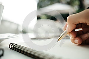 Business background hand of businessman with pen write on blank