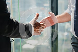 Business background of hand of businessman in suit going to having handshake