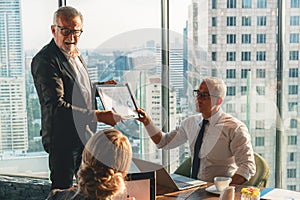 Business background of senior ceo discussing business project proposal with executive board in office boardroom