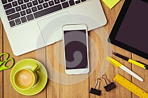 Business background with smartphone and laptop on office table. Smartphone mock up template.