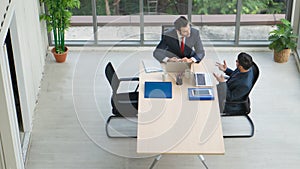 Business background of two businessmen having discussion together in office