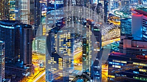 Business bay architecture by night with illuminated buildings, Dubai, United Arab Emirates.