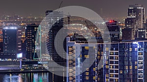 Business Bay Dubai skyscrapers with water canal aerial night timelapse.