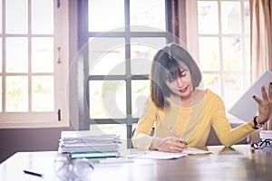 Business beautiful Asian woman working and writing note