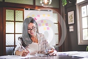 Business beautiful Asian woman working and writing note