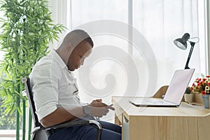 Business black american man, African person using a smartphone to chat on internet online with computer notebook laptop in
