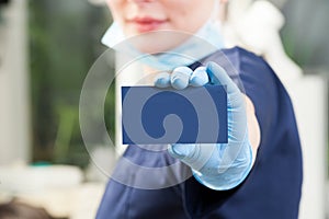 Business blank card closeup in female dentist hand