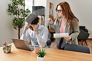 Business boss angry with stressed employee at the office