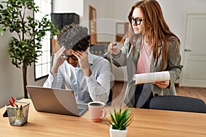 Business boss angry with stressed employee at the office