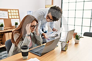 Business boss angry with stressed employee at the office