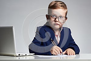 Business boy. funny child in glasses writing pen. little boss in office