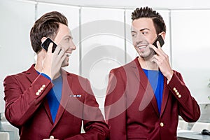 Business brothers twins with phones