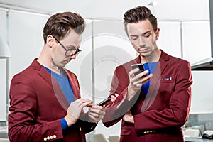 Business brothers twins with phones