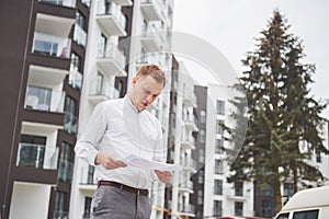 Business, building, industry, technology and people concept - smiling builder in hardhat with tablet pc computer over