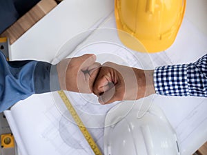 Business, building, teamwork, gesture and people concept - group of smiling builders in hardhats greeting each other with Hand