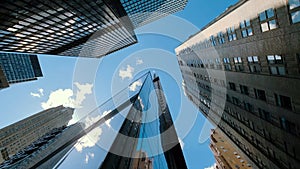 Business buildings skyline looking up with blue sky background. High-rise skyscraper, modern architecture