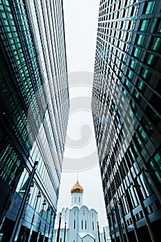 Business buildings skyline looking up with sky and churche, high-rise buildings, modern architecture