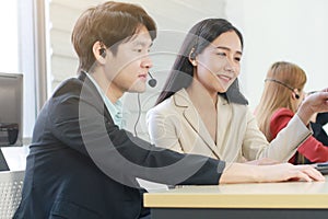 Business Call Center and technical Support staff or receptionist phone operator Discussing and working for teamwork with computer