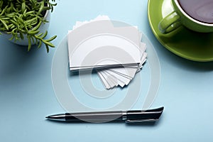 Business card blank over coffee cup and pen at office table. Corporate stationery branding mock-up