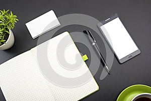 Business card blank, smartphone or tablet pc, flower and pen at office desk table top view. Corporate stationery