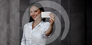 Business Card Mockup Image. a Smiling Mixed Races Business Woman showing a Blank Card photo
