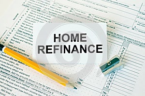 Business card with text Home Refinance on financial docs