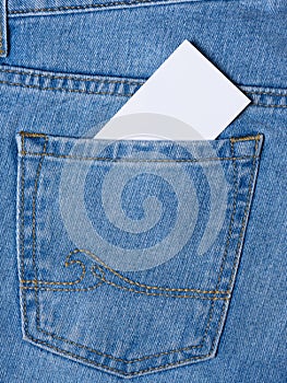 A business card is visible from a blue denim pocket.