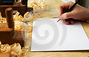 Business card on wooden table for carpenter tools with sawdust.