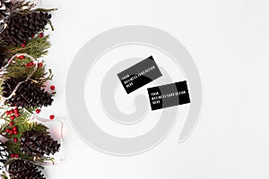 Business cards christmas composition for branding. fir branches, cones and christmas decorations on white background.