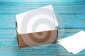 Business cards in paper box on wood desk