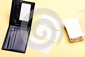 Business cards stack in card holder on yellow background