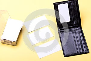 Business cards stack in card holder on yellow background
