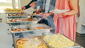 Business catering people take buffet food during company event