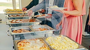 Business catering people take buffet food during company event