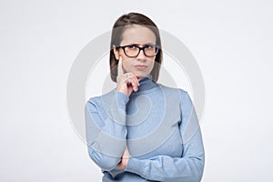 Business caucasian woman in glasses thinking trying to make a decision