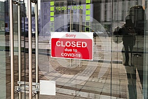 Business center closed due to COVID-19, sign with sorry in door window. Stores, restaurants, offices, other public places