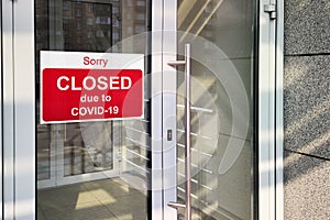 Business center closed due to COVID-19, sign with sorry in door window. Stores, restaurants, offices, other public places