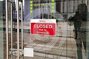Business center closed due to COVID-19, sign with sorry in door window. Stores, restaurants, offices, other public places photo