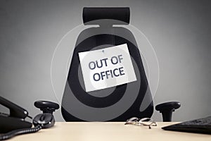 Business chair with out of office sign