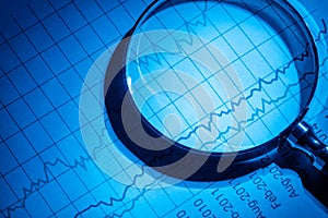 Business chart and magnifying glass