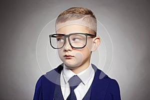 Business child in formal suit and glasses