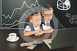 Business children uses a laptop computer. Business diagram, graph